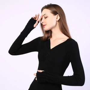 Detailed view of black cable knit arm warmers with thumb holes and ribbed texture