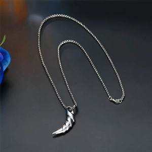 Punk style stainless steel necklace with silver beast claw pendant on dark background