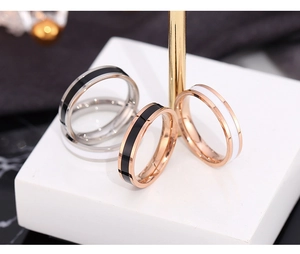 Macro detail of minimalist titanium steel rings in silver and rose gold with color inlay