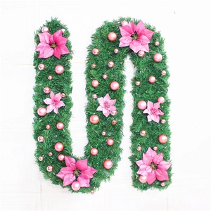 2.7m artificial Christmas garland with green needles, pink flowers and festive ornaments