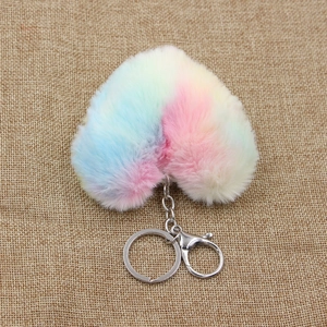 Rainbow gradient plush heart keychain with silver metal clip on linen background