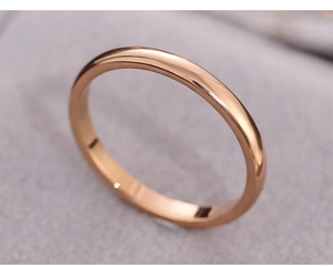 Macro shot of minimalist rose gold stainless steel ring on soft velvet background
