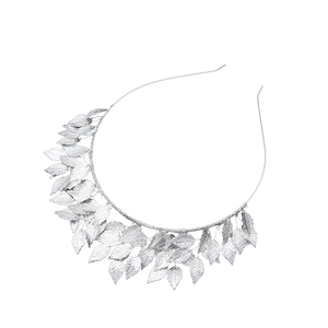 Macro shot of silver-plated leaf headband with intricate metallic texture details