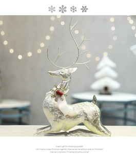 Close-up of reindeer figurine with gold texture and festive white scarf decoration