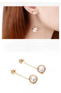 Detail view of gold star and planet drop earrings with shell pearls and measurements