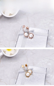 Close-up of star and pearl drop earrings in rose gold and gold plating on marble background