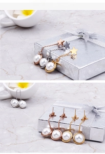 Star-shaped pearl drop earrings in gold, silver and rose gold displayed in a gift box