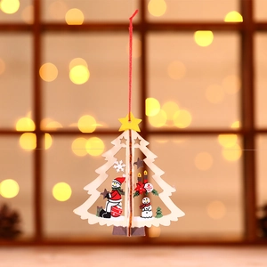 Laser-cut wooden Christmas tree ornament with Santa and snowman motifs in festive warm light