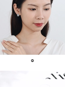 Close-up of elegant silver teardrop cubic zirconia stud earring on a female model