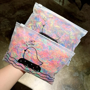 Close-up of colorful elastic hair bands in cartoon frosted zipper bags for toddlers