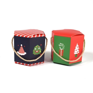 Christmas gift boxes with festive patterns and gold rope handles in blue and red colors