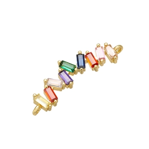 Detail of S-shaped gold connector featuring micro-set multi-color cubic zirconia stones