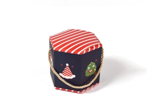Detail of hexagonal Christmas gift box with dark blue base and red striped lid