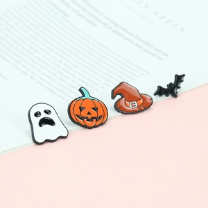Set of four Halloween enamel pins featuring ghost, pumpkin, bat, and wizard hat details