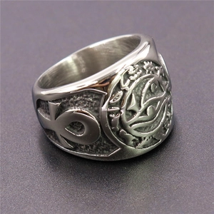 Macro detail of silver stainless steel ring featuring Eye of Horus and Ankh symbols