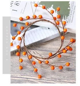 Close-up of orange berry wreath with natural twigs on a vintage magazine surface