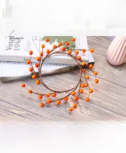Macro shot of artificial orange berry wreath base with realistic rustic twig textures