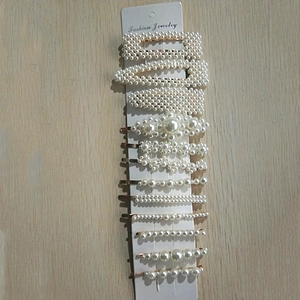 Detail of 11-piece set featuring pearl and gold metal hair clips on display card