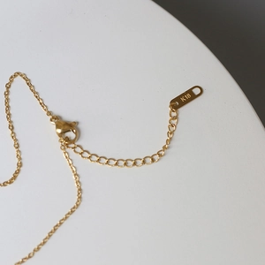 Detail of 18K gold-plated crescent necklace lobster clasp and adjustable extension chain