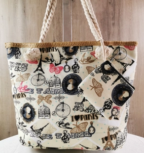 Detail of Paris-themed canvas beach tote and clutch set with rope handles on wood background