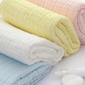 Close-up of soft multi-layer cotton muslin baby towels in pastel colors and bubble texture