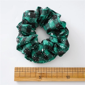 Green and black plaid Christmas scrunchie with snowflakes and a measurement scale