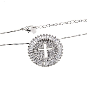 Detailed view of silver cross pendant with baguettes and round cubic zirconia stones