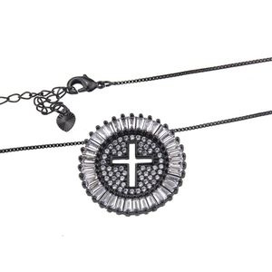 Macro detail of black plated cross pendant with round and baguette cut zircons