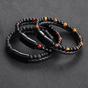 Detailed close-up of multilayer braided leather bracelet with tiger eye and natural stones