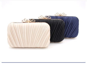 Detailed pleated satin evening clutch bags in cream, black and blue with bow clasp