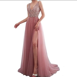 Detail of sequin embroidery and sheer mesh layers on a deep V-neck slit evening gown