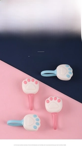 Close-up of pink and blue cat paw duvet clips in soft silicone and ABS material