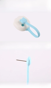 Detail of cat paw quilt clip showing the secure metal needle and easy release button mechanism