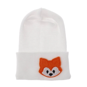 Detailed view of white knit baby beanie featuring an orange fox embroidery patch