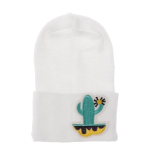 Close-up of white knitted baby beanie with cactus embroidery patch and roll-up cuff detail