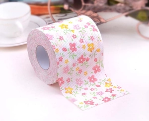 Detail shot of white toilet paper roll featuring vibrant pink and yellow floral prints