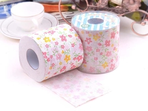 Close-up of floral printed roll tissue with delicate pink and yellow flower patterns