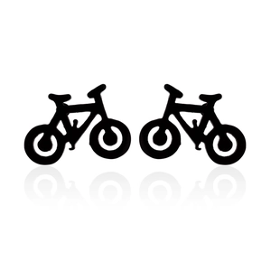 Minimalist matte black bicycle stud earrings for women on a white reflective surface