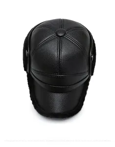 Top view of a black winter baseball cap with faux fur ear flaps and leather texture