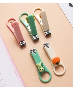 Detailed top view of five colorful cartoon nail clippers with cute dinosaur and pumpkin shapes