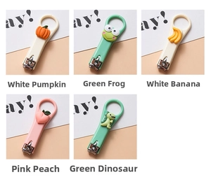 Detail view of five cartoon nail clippers in pumpkin frog banana peach and dinosaur shapes