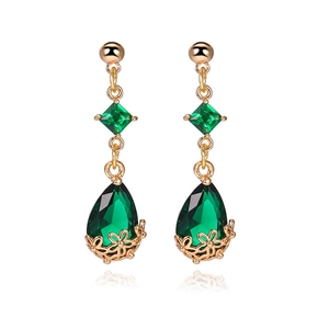 Detailed macro of 18K gold drop earrings with deep green waterdrop crystal pendants