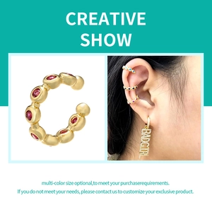 Golden ear bone cuff with micro-pave red cubic zirconia and model wearing multiple styles