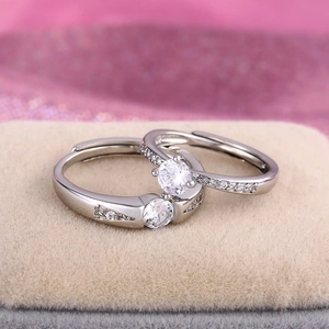 Macro view of couple rings with round zircon setting on a velvet display stand