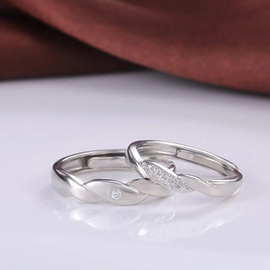 Silver couples intertwining wave rings set with sparkling diamonds for proposal