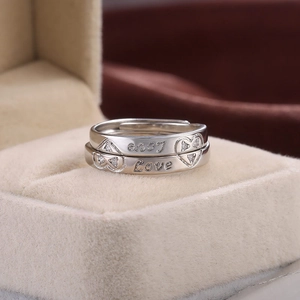 Macro shot of silver couple rings with love and only engraving in a jewelry box