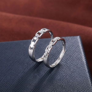 Matching silver chain couple rings with cubic zirconia inlay on polished metal bands