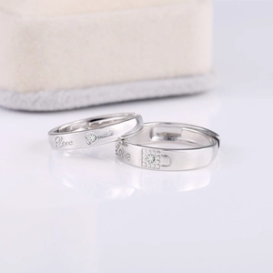 Matching silver plated couple rings with key and lock patterns and Love engraving