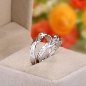 Macro shot of silver couples rings with Promise engraving and S925 stamp in a gift box