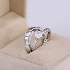 Close-up of silver-plated couples rings with cubic zirconia in a velvet jewelry box